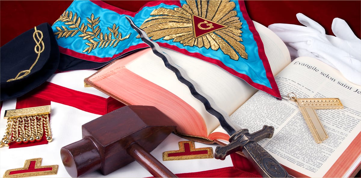 Lodge regalia: apron, collar, gavel, sword, and the Volume of the Sacred Law.